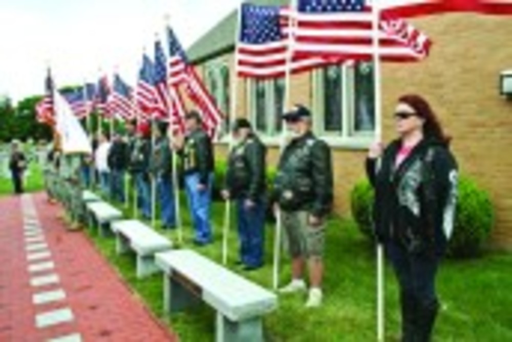       Patriot Guard riders stand at attention during the Memorial Day observance. /Courtesy of the Warwick Beacon